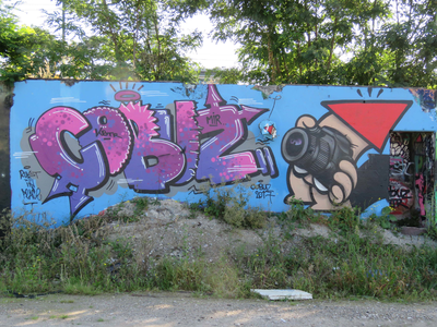 833752 Afbeelding van graffiti met de tekst 'COBUZ' met rechts een fotograferende KBTR uit 2017, op een muur langs het ...